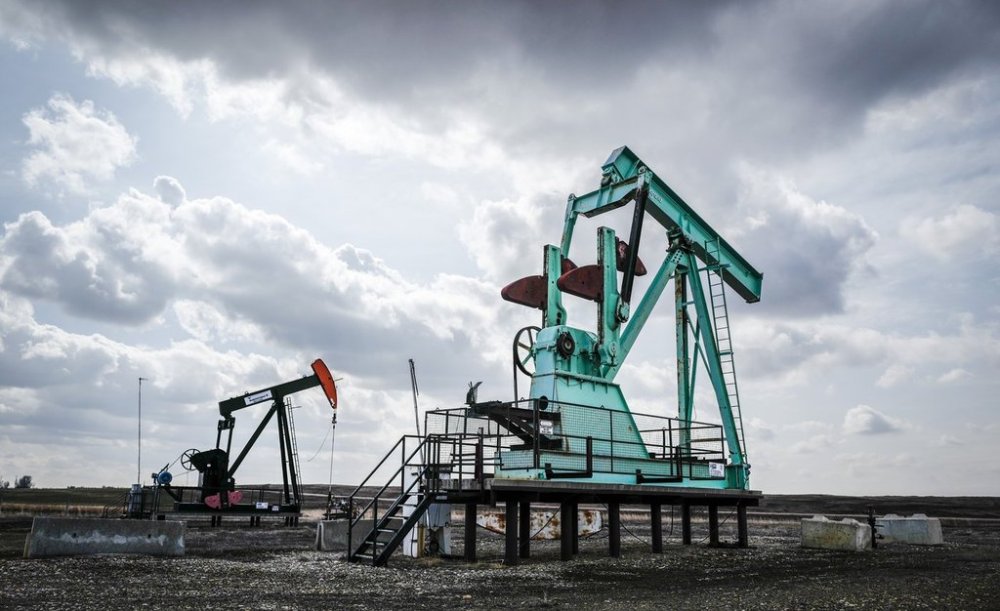 A decommissioned pumpjack, right, sits idle beside a functioning one drawing out oil and gas from a well head near Carstairs, Alta., Tuesday, April 1, 2025. THE CANADIAN PRESS/Jeff McIntosh