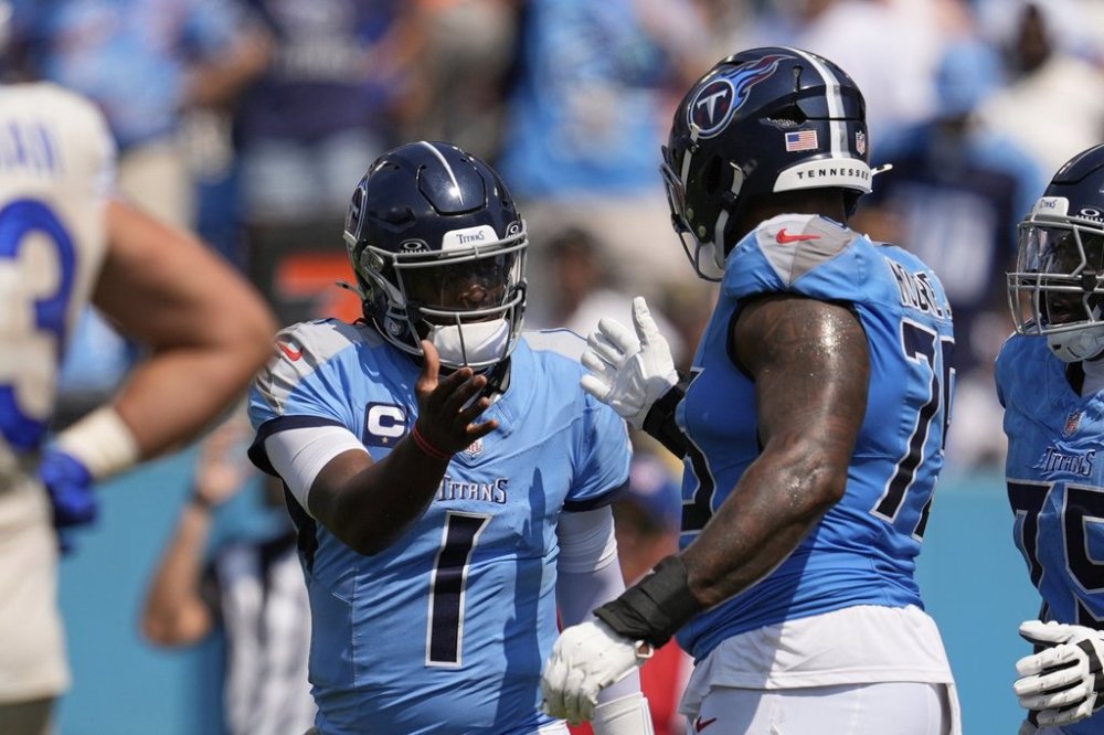 Tennessee Titans quarterback Cam Ward, left, celebrates with offensive tackle Dan Moore Jr. after throwing a touchdown pass during the first half of an NFL football game against the Los Angeles Rams, Sunday, Sept. 14, 2025, in Nashville, Tenn. (AP Photo/George Walker IV)