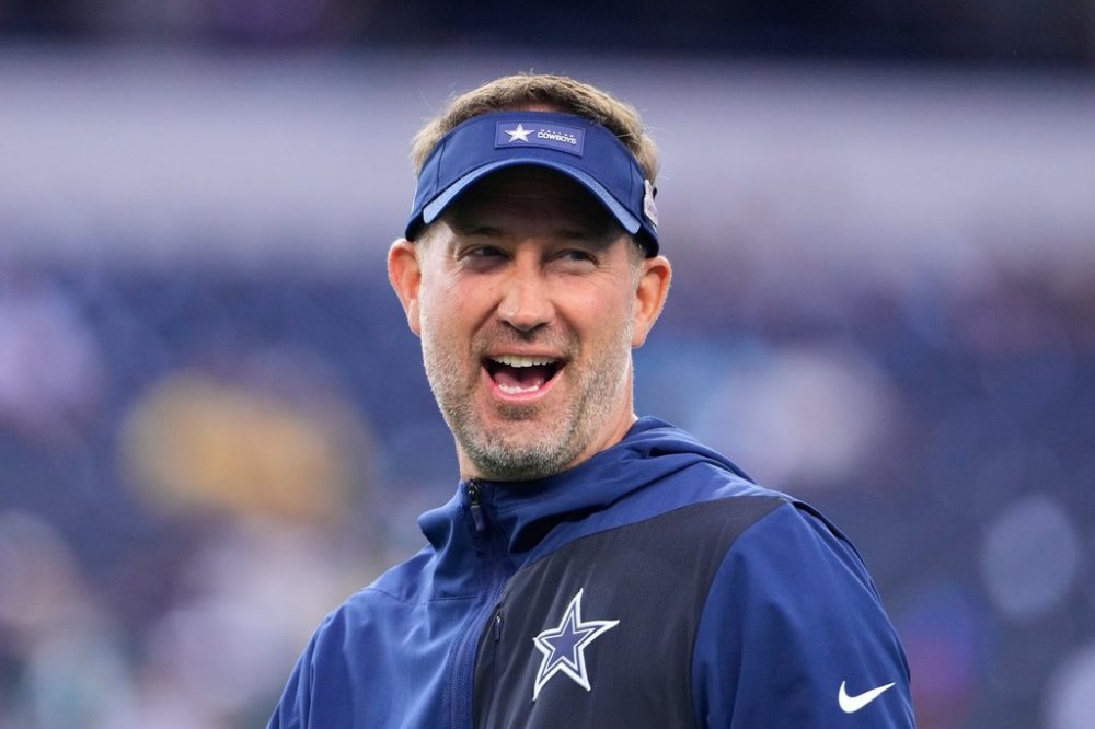Dallas Cowboys head coach Brian Schottenheimer walks across the field during warmups before an NFL football game against the Green Bay Packers Sunday, Sept. 28, 2025, in Arlington, Texas. (AP Photo/Jeffrey McWhorter)