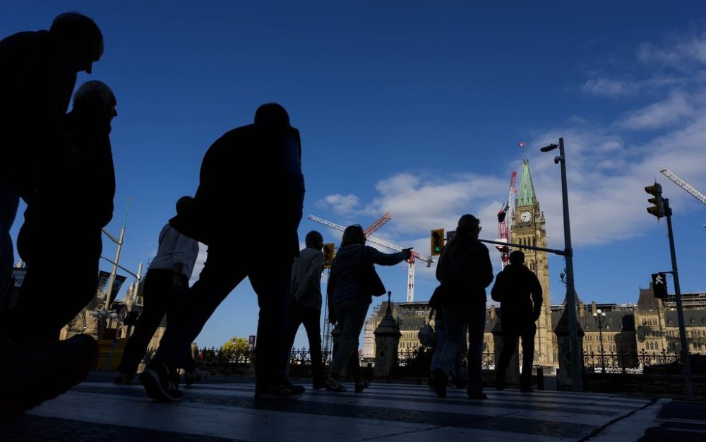 People cross Wellington Street on their way to Parliament Hill, a day before the return of the House of Commons, on Sunday, Sept. 14, 2025. THE CANADIAN PRESS/Justin Tang