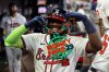 Atlanta Braves' Michael Harris II flashes a chain to the crowd after hitting a solo home run in the seventh inning of a baseball game against the Washington Nationals, Tuesday, Sept. 23, 2025, in Atlanta. (AP Photo/Colin Hubbard)