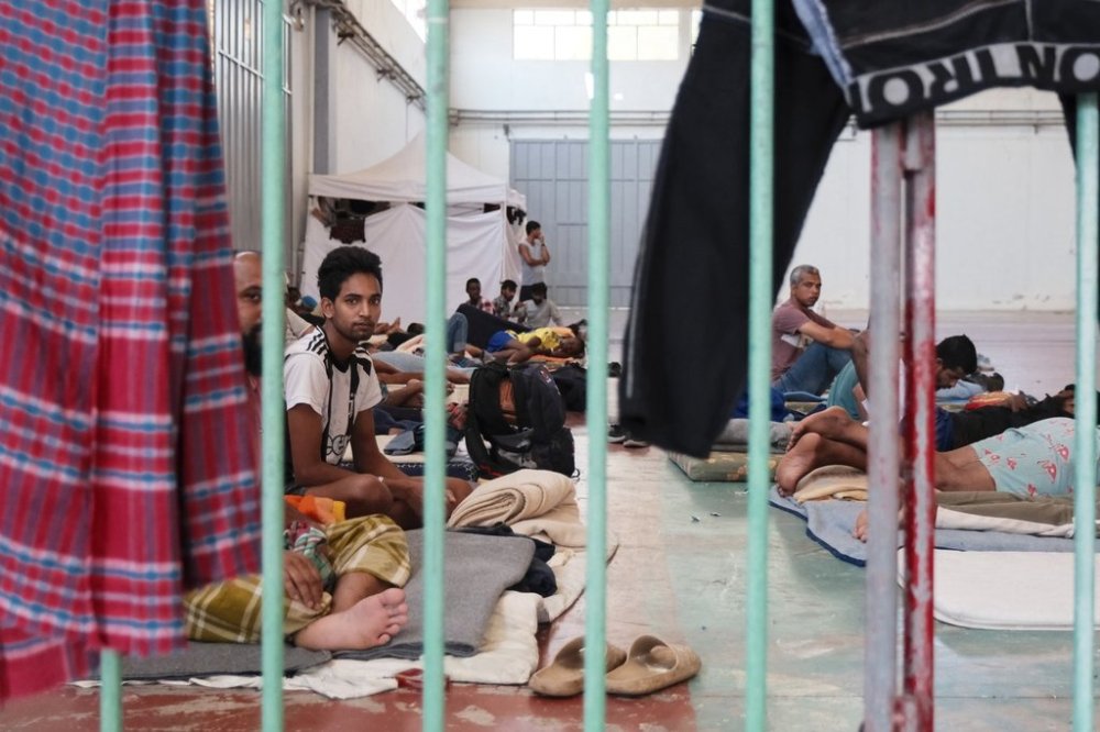 Migrants who arrived recently at the island of Crete, despite a suspension of asylum claims and plans for tougher detention rules, are being held under guard at a temporary shelter in the village of Agia, near Chania city, on the island of Crete, southern Greece, Tuesday, Aug. 19, 2025. (AP Photo/Giannis Angelakis)