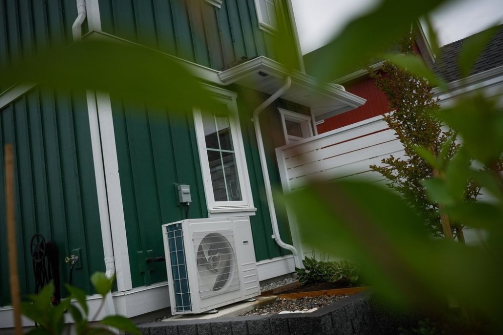 A heat pump unit is seen outside a new single family house billed as an estate cottage, in Delta, B.C., on Monday, Aug. 12, 2024. THE CANADIAN PRESS/Darryl Dyck