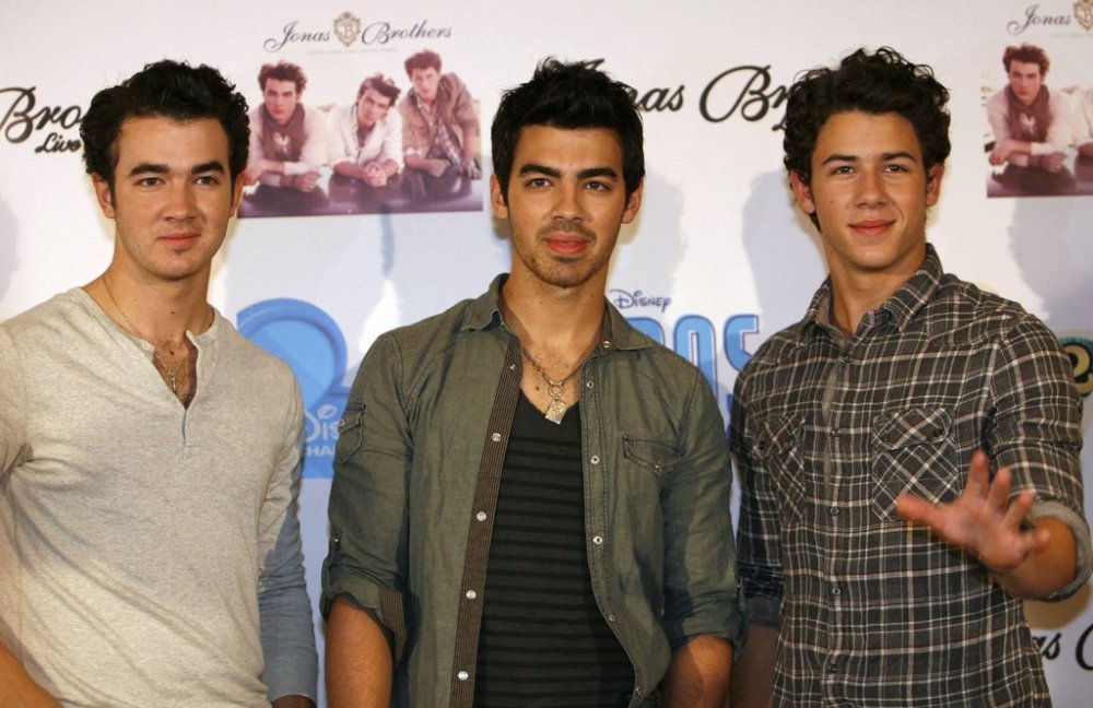 The Jonas Brothers, from left, Kevin, Joe and Nick pose for photographers during the presentation of their latest album