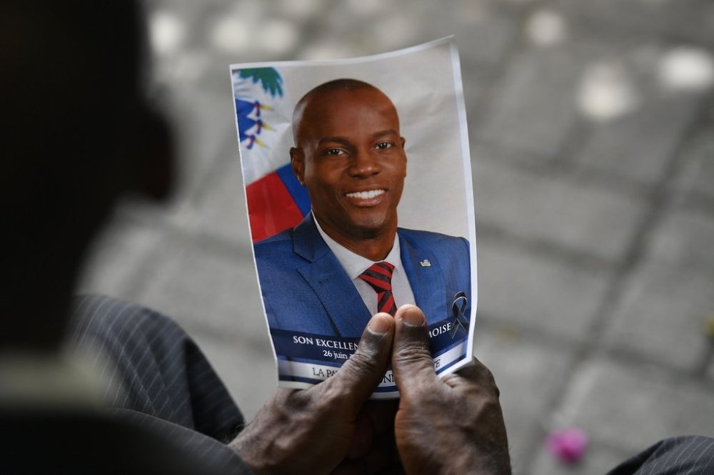 A person holds a photo of late Haitian President Jovenel Moise during his memorial ceremony at the National Pantheon Museum in Port-au-Prince, Haiti, Tuesday, July 20, 2021. THE CANADIAN PRESS/AP/Matias Delacroix