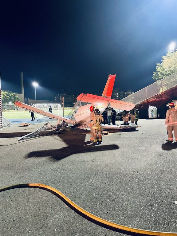 Firefighters are seen responding to a small aircraft that crashed next to the field at Monarch Park Collegiate Institute, in Toronto, in a Monday, Sept. 15, 2025, handout image published by Toronto Fire Chief Jim Jessop to social media site X. THE CANADIAN PRESS/Handout - @ChiefJessopTFS, (Mandatory Credit)