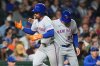 New York Mets' Francisco Lindor, left, is congratulated by third base coach Mike Sarbaugh after hitting a solo home run during the third inning of a baseball game against the Chicago Cubs in Chicago, Thursday, Sept. 25, 2025. (AP Photo/Nam Y. Huh)