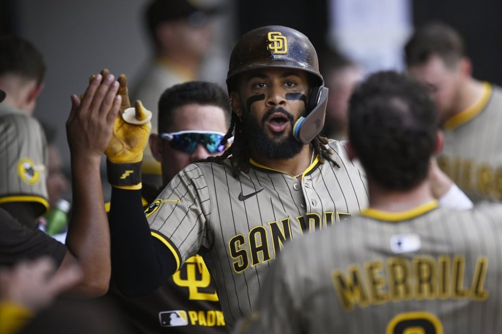 San Diego Padres' Fernando Tatis Jr. celebrates with teammates in the dugout after hitting a solo home run during the third inning of a baseball game against the Chicago White Sox, Sunday, Sept. 21, 2025, in Chicago. (AP Photo/Paul Beaty)