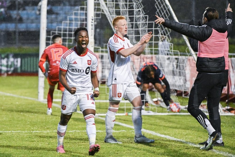 Toronto FC forward Cassius Mailula (12) reacts to a goal by teammate Matty Longstaff, centre, against CS Saint-Laurent during second half Canadian Championship quarterfinal soccer action in Montreal, Wednesday, May 8, 2024. THE CANADIAN PRESS/Graham Hughes