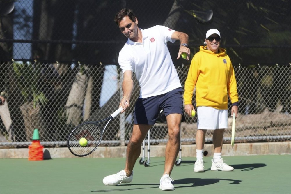 Co-creator of the Laver Cup Roger Federer hits tennis balls to local youth tennis players during a court unveiling at John McLaren Park Tennis Courts before the Laver Cup tennis matches in San Francisco, Tuesday, Sept. 16, 2025. (AP Photo/Jeff Chiu)