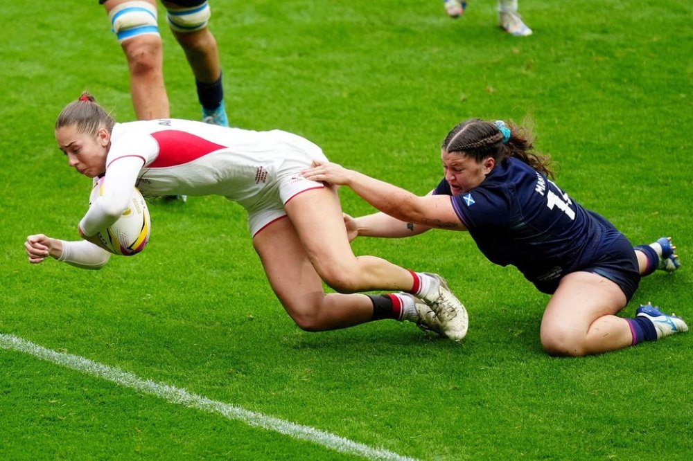 England's Holly Aitchison, left, scores during the Women's Rugby World Cup 2025 quarter-final match between England and Scotland in Bristol, England, Sunday Sept. 14, 2025. (Andrew Matthews/PA via AP)