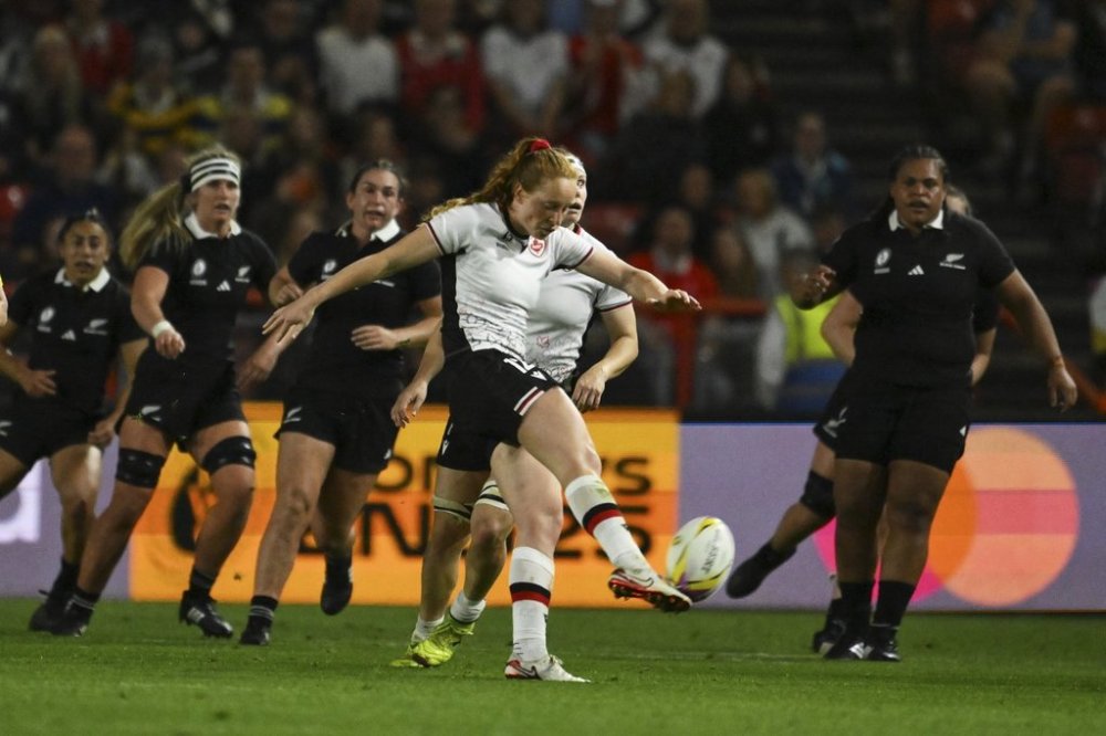 Canada's Alex Tessier kicks the ball during the Women's Rugby World Cup 2025 semifinal match between New Zealand and Canada in Bristol, England, Friday, Sept. 19, 2025.(AP Photo/Anthony Upton)