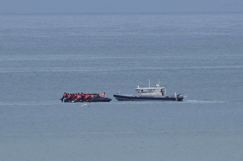 FILE - A boat thought to carry migrants is escorted by a vessel from the French Gendarmerie Nationale in the English Channel off Wimereux beach, France, Wednesday, Sept. 4, 2024. (AP Photo/Nicolas Garriga, File)