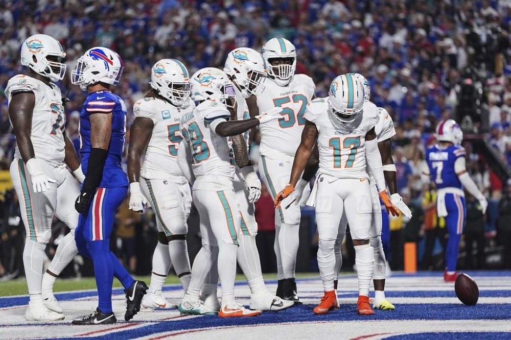 Miami Dolphins wide receiver Jaylen Waddle (17) celebrates with teammates after scoring a touchdown during the first half of an NFL football game against the Buffalo Bills, Thursday, Sept. 18, 2025, in Orchard Park, N.Y. (AP Photo/Matt Rourke)