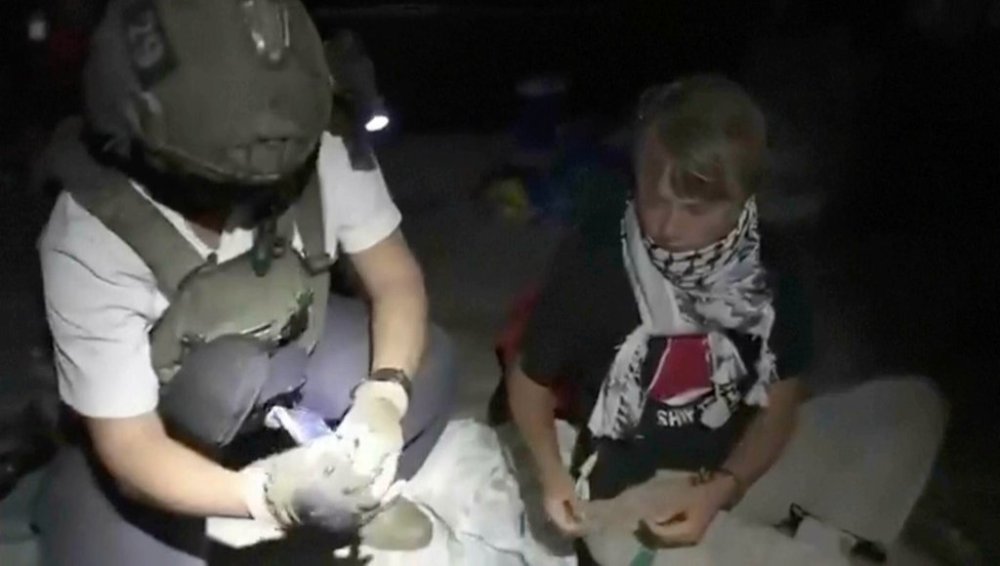 This image taken from video released by the Israeli Foreign Ministry claims to show activist Greta Thunberg, right, as she is removed after the Israeli navy intercepted the Global Sumud Flotilla carrying humanitarian aid towards Gaza on Wednesday, Oct. 1, 2025. (Israeli Foreign Ministry via AP)