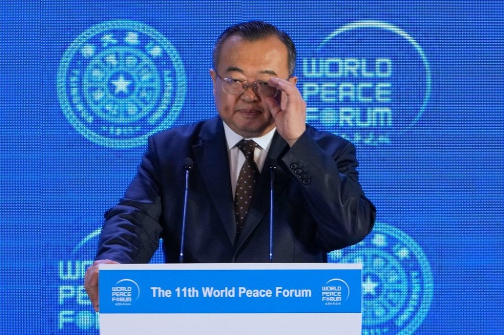 FILE - Liu Jianchao, Minister of the International Department of the Chinese Communist Party Central Committee adjusts his glasses during a Q&A session for a lunch meeting of the 11th World Peace Forum at a hotel in Beijing, July 2, 2023. .(AP Photo/Andy Wong, File)