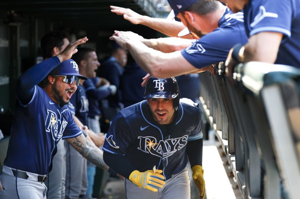 Tampa Bay Rays pinch hiter Nick Fortes celebrates with teammates in the dugout after hitting a solo home run against the Chicago Cubs during the ninth inning of a baseball game Saturday, Sept. 13, 2025, in Chicago. (AP Photo/Kamil Krzaczynski)