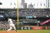 Seattle Mariners' Cal Raleigh hits a solo home run during the first inning of a baseball game against the Colorado Rockies, Wednesday, Sept. 24, 2025, in Seattle. (AP Photo/Ryan Sun)
