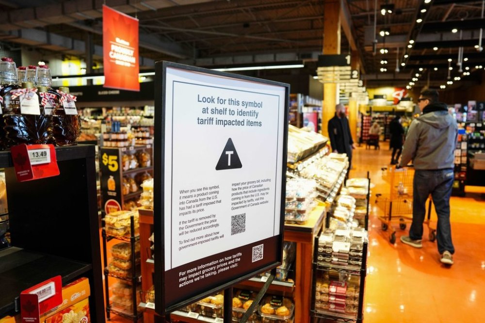 A sign advising shoppers of tariffs impacts is seen in a grocery store in Ottawa on Wednesday, April 2, 2025. THE CANADIAN PRESS/Justin Tang