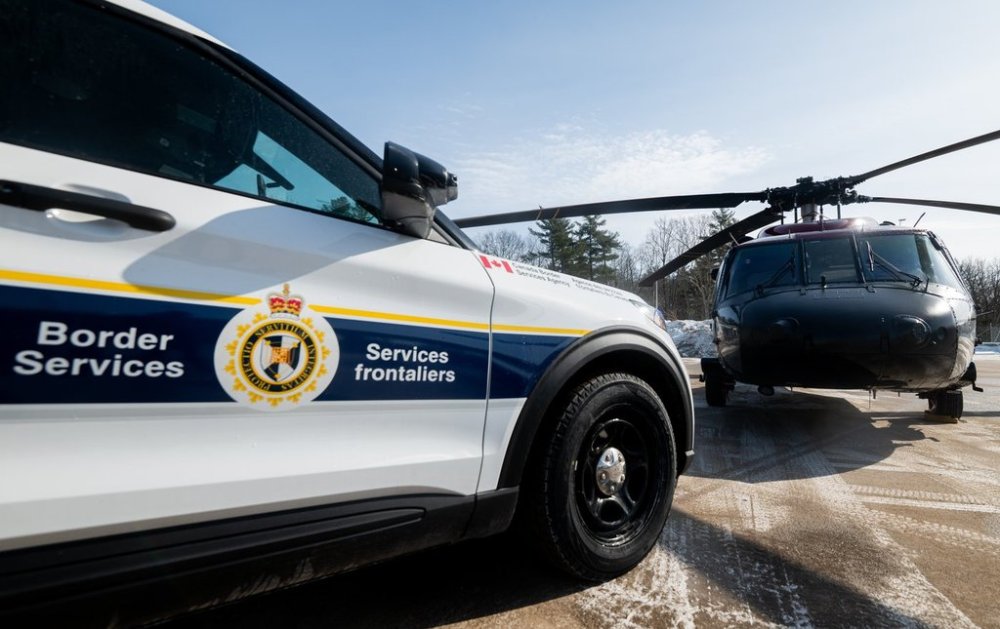 A Canada Border Services Agency (CBSA) marked cruiser is parked next to a RCMP Sikorsky UH-60 Black Hawk at the CBSA Lansdowne Port of Entry in Lansdowne, Ont., on Wednesday, Feb. 12, 2025. THE CANADIAN PRESS/Spencer Colby