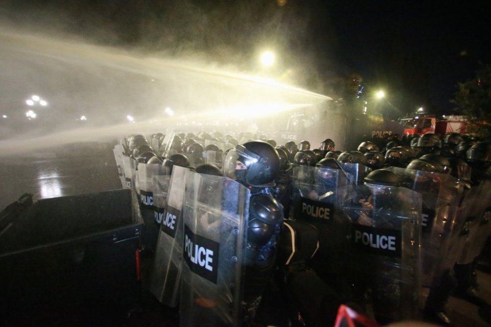 Police use a water cannon to block protesters during an opposition rally in the city center of Tbilisi, Georgia, on Saturday, Oct. 4, 2025, boycotting the municipal elections and call for the release of political opponents. (AP Photo/Zurab Tsertsvadze)
