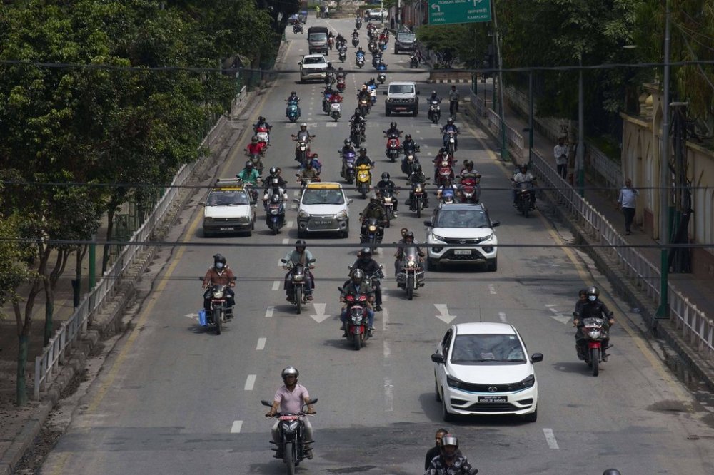 Vehicles move along the road after authorities lifted a days-long curfew imposed during anti-corruption protests sparked by a short-lived social media ban in Kathmandu, Nepal, Saturday, Sept. 13, 2025. (AP Photo/Niranjan Shrestha)