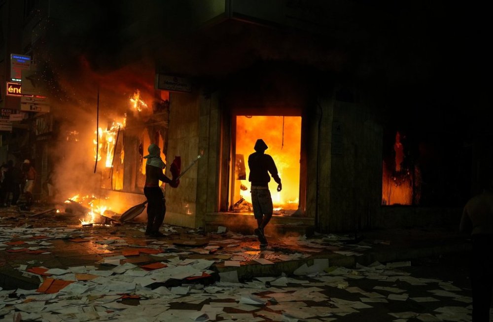 People torch and loot a bank as youth led protests calling for healthcare and education reforms turned violent, in Sale, Morocco, Wednesday, Oct. 1, 2025. (AP Photo/Mosa'ab Elshamy)