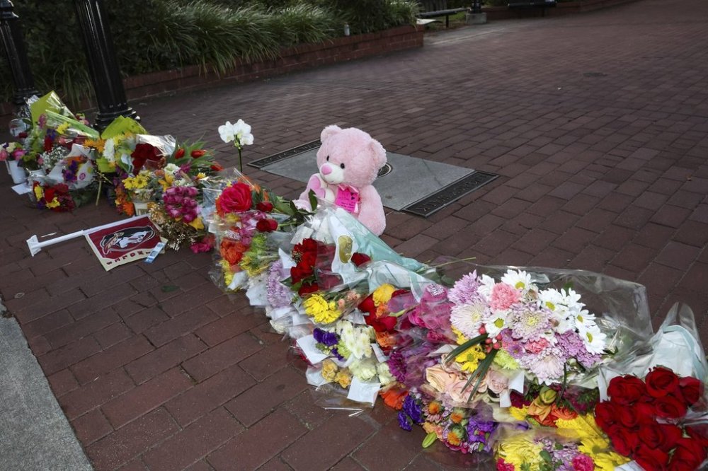 FILE - An impromptu memorial of flowers and other items laid near the center of the Florida State campus in sight of the Student Union building, Tallahassee, Fla., April 17, 2025. (AP Photo/Gary McCullough, File)