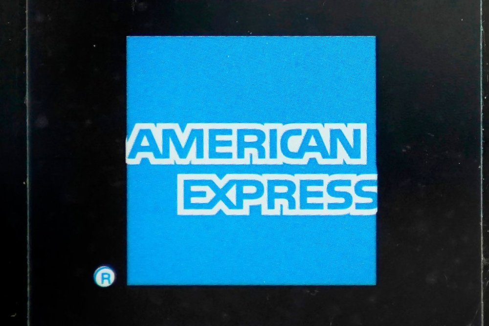 FILE - An American Express logo is attached to a door in Boston's Seaport District, Wednesday, July 21, 2021. (AP Photo/Steven Senne, File)