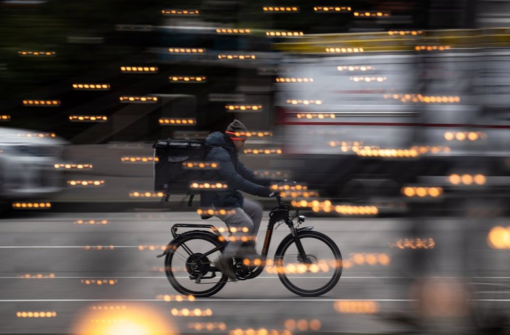 Today, food delivery apps may be a misnomer, said Vince Sgabellone, food service industry analyst for research firm Circana. A food delivery worker rides a bike in downtown Vancouver, B.C., Thursday, Dec. 23, 2021. THE CANADIAN PRESS/Darryl Dyck