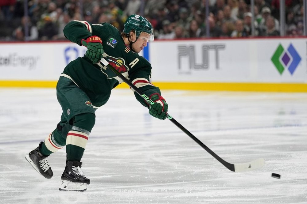 FILE - Minnesota Wild left wing Kirill Kaprizov (97) shoots the puck during the third period of an NHL hockey game against the San Jose Sharks, April 9, 2025, in St. Paul, Minn. (AP Photo/Abbie Parr, file)
