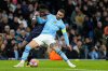 FILE - Manchester City's Kyle Walker, right, is challenged by Real Madrid's Vinicius Junior during the Champions League quarterfinal second leg soccer match between Manchester City and Real Madrid at the Etihad Stadium in Manchester, England, Wednesday, April 17, 2024. (AP Photo/Dave Shopland, file)