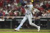 Milwaukee Brewers' Christian Yelich hits a solo home run in the sixth inning of a baseball game against the Cincinnati Reds, Friday, Aug. 15, 2025, in Cincinnati. (AP Photo/Kareem Elgazzar)