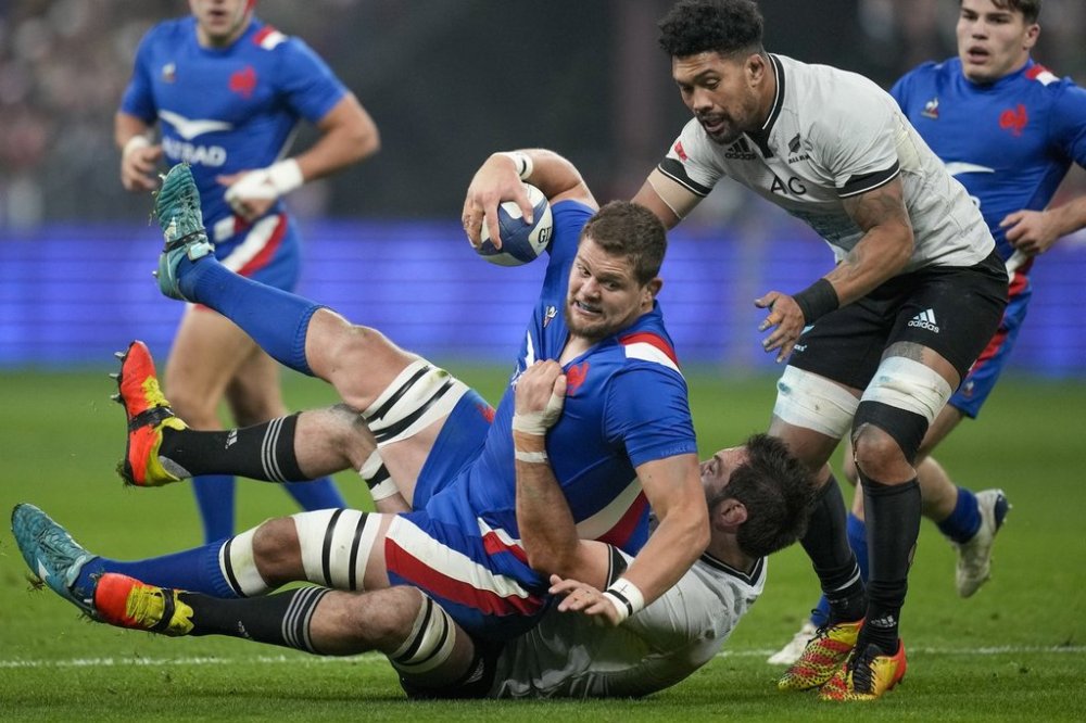 FILE - France's Paul Willemse is tackled by New Zealand's Sam Whitelock and Ardie Savea during the international rugby union match between France and the All Blacks, at the Stade de France, in Saint Denis, north of Paris, Nov. 20, 2021. (AP Photo/Christophe Ena, File)