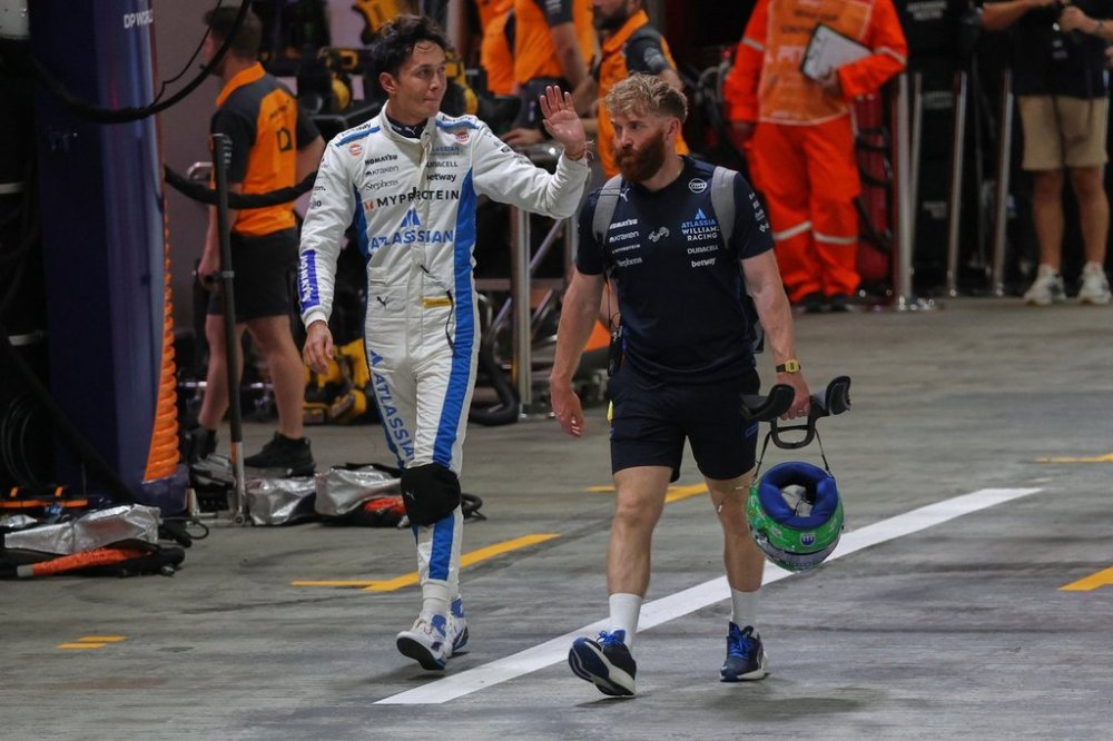 Williams driver Alexander Albon of Thailand walks through the pit lane during the qualifying for the Singapore Formula One Grand Prix at the Marina Bay Street Circuit in Singapore, Saturday, Oct. 4, 2025. (AP Photo/Fazry Ismail, Pool)