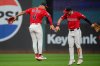 Cleveland Guardians' Brayan Rocchio (4) and Steven Kwan, right, celebrate at the end of a baseball game against the Detroit Tigers, Wednesday, Sept. 24, 2025, in Cleveland. (AP Photo/Phil Long)