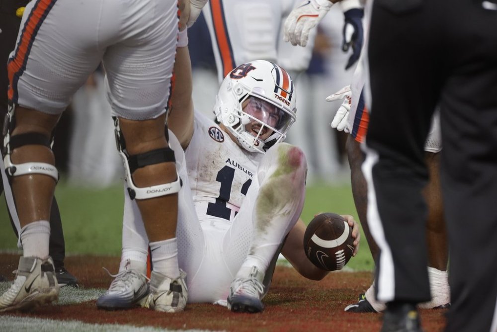 Auburn quarterback Jackson Arnold (11) gets help up after being sacked during the second half of an NCAA college football game against Oklahoma on Saturday, Sept. 20, 2025, in Norman, Okla. (AP Photo/Alonzo Adams)