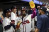 Atlanta Braves' Ronald Acuña Jr., center, high-fives teammates in the dugout after scoring in the third inning of a baseball game against the Washington Nationals, Monday, Sept. 22, 2025, in Atlanta. (AP Photo/Colin Hubbard)