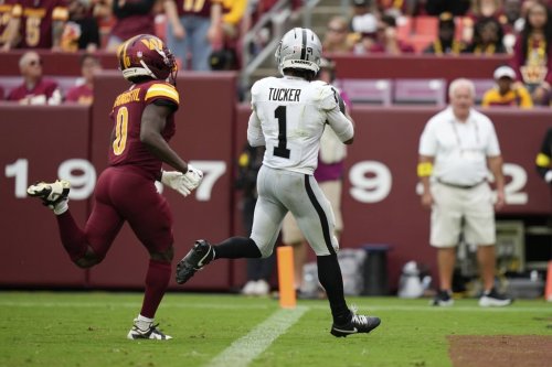 Las Vegas Raiders wide receiver Tre Tucker (1) scores a touchdown as Washington Commanders cornerback Mike Sainristil (0) defends during the second half of an NFL football game Sunday, Sept. 21, 2025, in Landover, Md. (AP Photo/Stephanie Scarbrough)