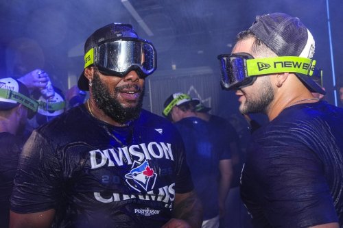 Toronto Blue Jays Vladimir Guerrero Jr. and Bo Bichette celebrate with teammates after winning the American League East Division title following MLB baseball action against the Tampa Bay Rays, in Toronto, Sunday, Sept. 28, 2025. THE CANADIAN PRESS/Chris Young