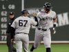 New York Yankees designated hitter Aaron Judge, right, fist-bumps third base coach Luis Rojas (67) after hitting a home run during the first inning of a baseball game against the Boston Red Sox, Friday, Sept. 12, 2025, in Boston. (AP Photo/Mark Stockwell)
