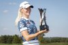 Charley Hull, of England, holds the trophy after winning the Kroger Queen City Championship golf tournament, Sunday, Sept. 14, 2025, at TPC River's Bend in Cincinnati. (AP Photo/Tanner Pearson)