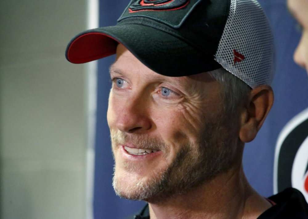 FILE - Tom Dundon, majority owner of the Carolina Hurricanes, talks to the media about his $250 million investment in the Alliance of American Football league before an NHL hockey game against the New York Rangers in Raleigh, N.C., Feb. 19, 2019. (AP Photo/Chris Seward, File)