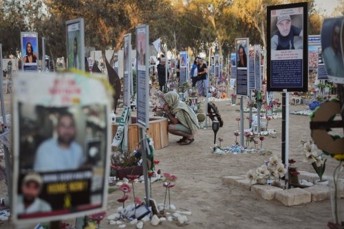People visit the site of the Nova music festival, where hundreds of revelers were killed and abducted by Hamas and taken into Gaza, as Israel marks the second year anniversary of the attack, near Kibbutz Reim, southern Israel, Tuesday, Oct. 7, 2025. (AP Photo/Ariel Schalit)