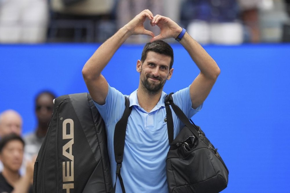 Novak Djokovic, of Serbia, acknowledges the crowd after losing to Carlos Alcaraz, of Spain, during the men's singles semifinals of the U.S. Open tennis championships, Friday, Sept. 5, 2025, in New York. (AP Photo/Seth Wenig)