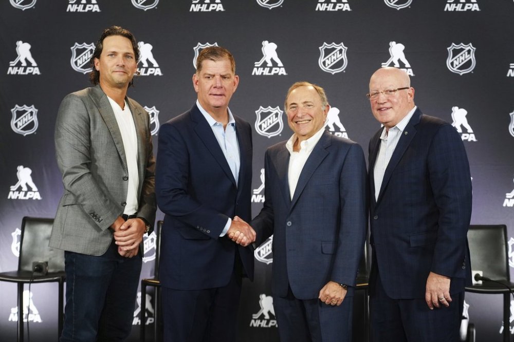 FILE — From left to right, Ron Hainsey, NHLPA Assistant Executive Director, Marty Walsh, NHLPA Executive Director, Gary Bettman, NHL Commissioner, and Bill Daly, NHL Deputy Commissioner, pose for photos after a joint press conference before the NHL hockey draft, June 27, 2025, in Los Angeles. (AP Photo/Damian Dovarganes, file)