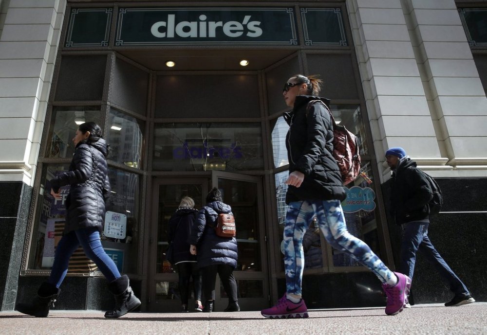 People walk past a Claire's store, Monday, March 19, 2018, in downtown Chicago. (AP Photo/Kiichiro Sato)