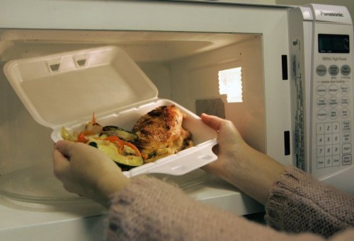 Food in a takeout container is placed in a microwave in this undated photo. THE CANADIAN PRESS/Nathan Denette
