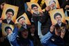 Hezbollah's al-Mahdi Scouts hold pictures of Hezbollah's former leader Hassan Nasrallah and his cousin and successor Hashem Safieddine, to marking the first anniversary of their assassination, who were killed in Israeli airstrikes, at Sports City Stadium in Beirut, Lebanon, Sunday, Oct. 12, 2025. (AP Photo/Bilal Hussein)