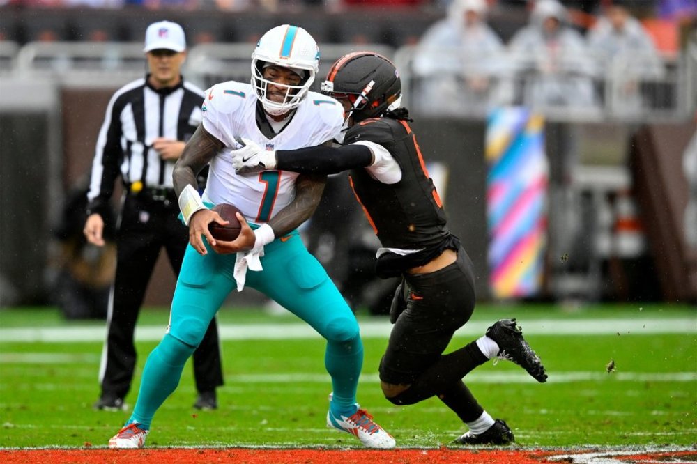 Miami Dolphins quarterback Tua Tagovailoa (1) is hit in the first half of an NFL football game between the Dolphins and the Cleveland Browns in Cleveland, Sunday, Oct. 19, 2025. (AP Photo/David Richard)